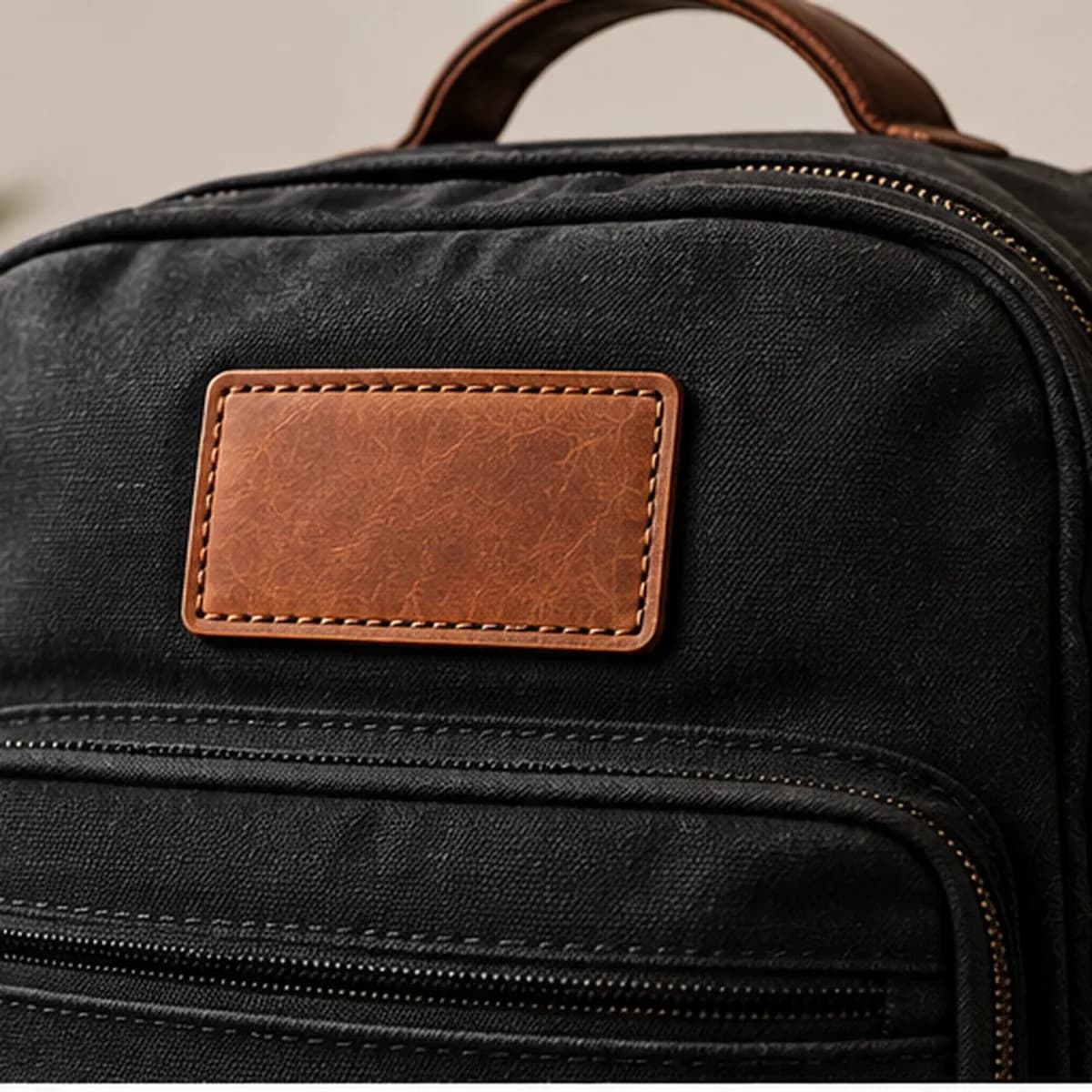 A leather patch on a canvas backpack